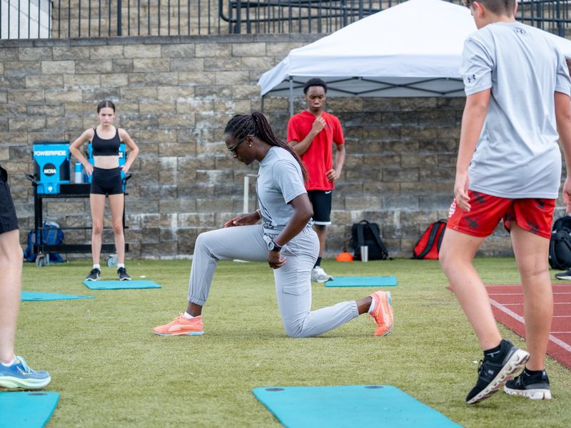 Athletes training on turf at an indoor facility