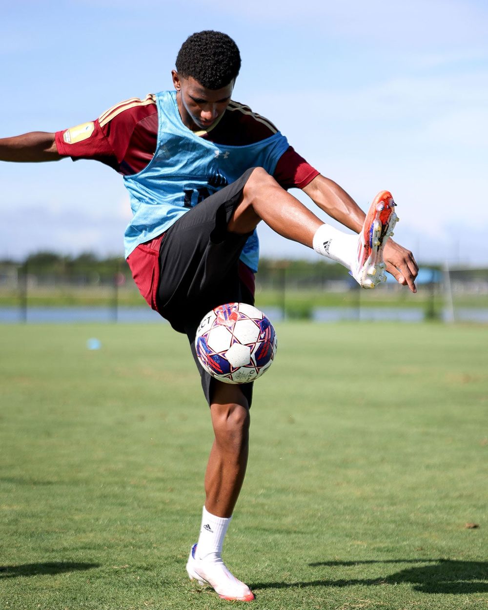 A player juggling a ball on a training pitch in the USA