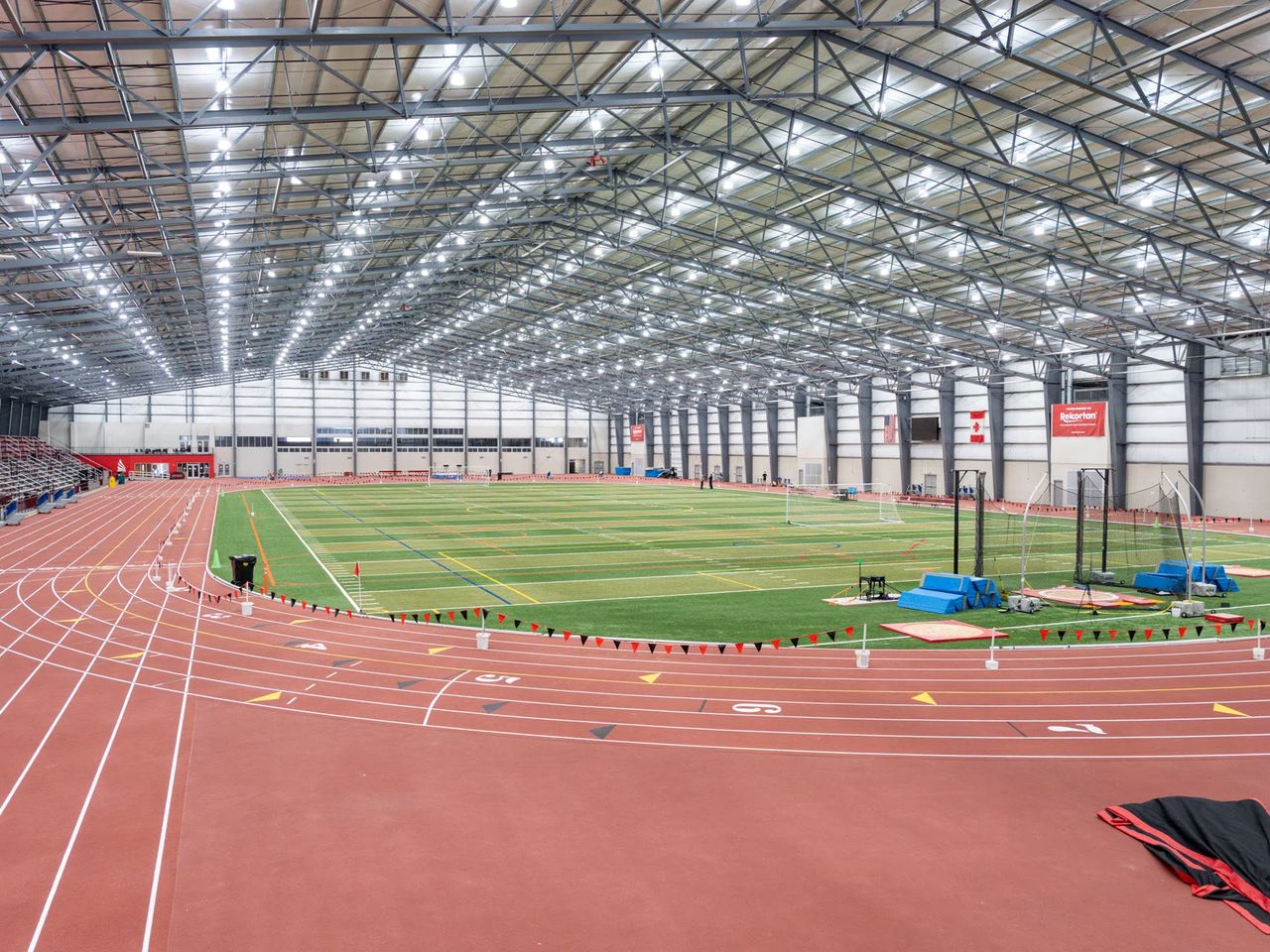 Players training on an indoor track and turf facility in the USA